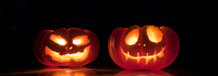 two illuminated jack-o-lanterns